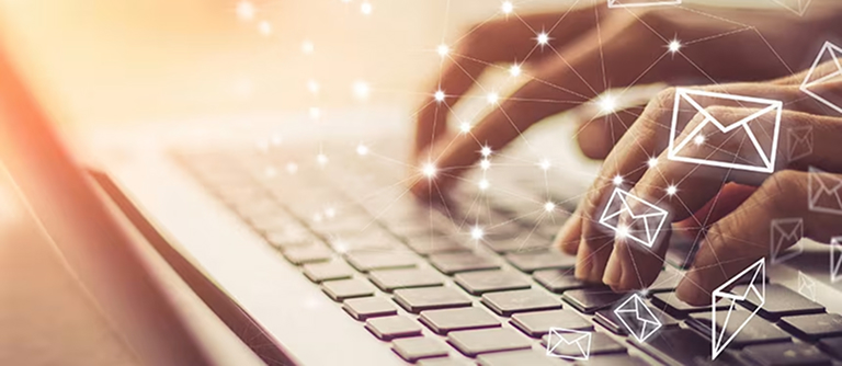 ノートパソコンのキーボードでメールを打ち込む両手背景